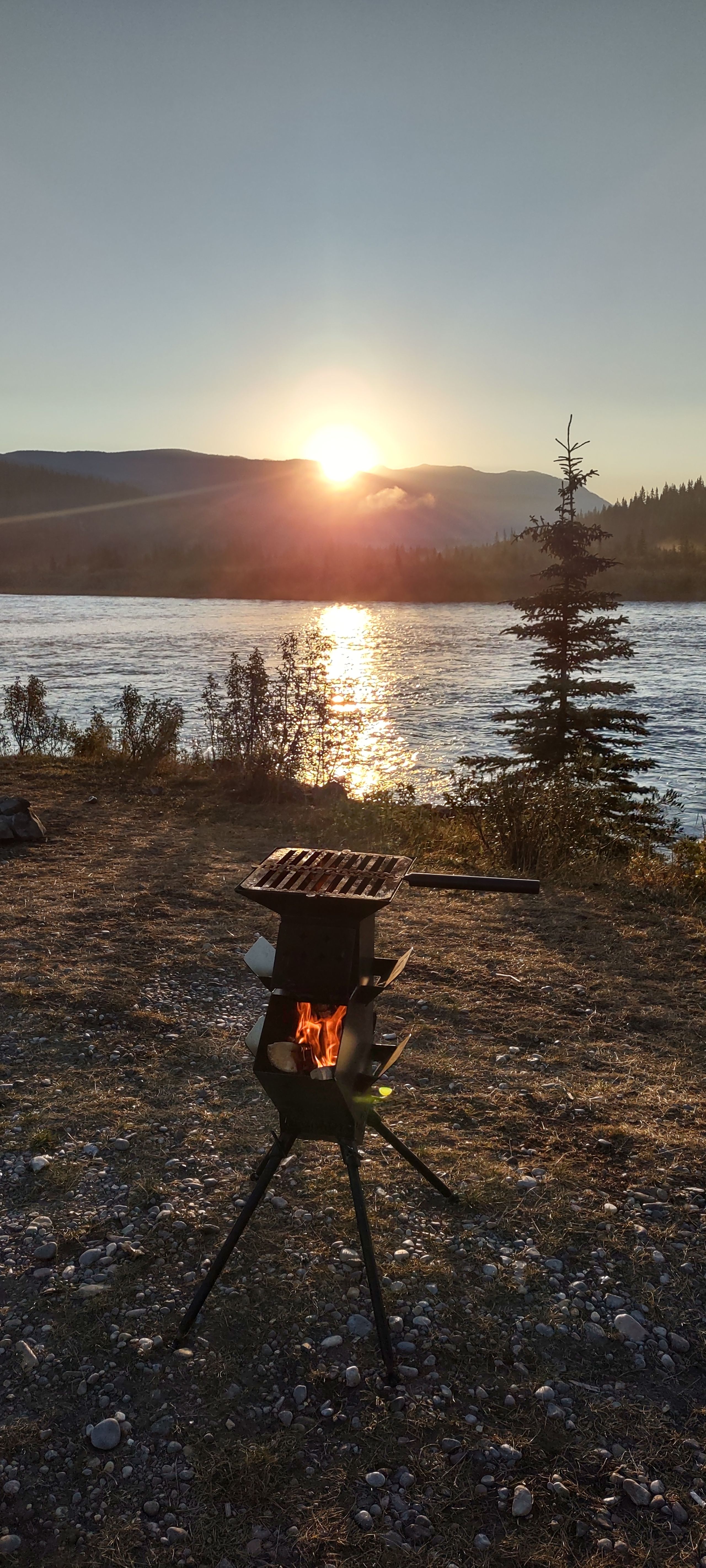 rocket stove against a sunrise backdrop