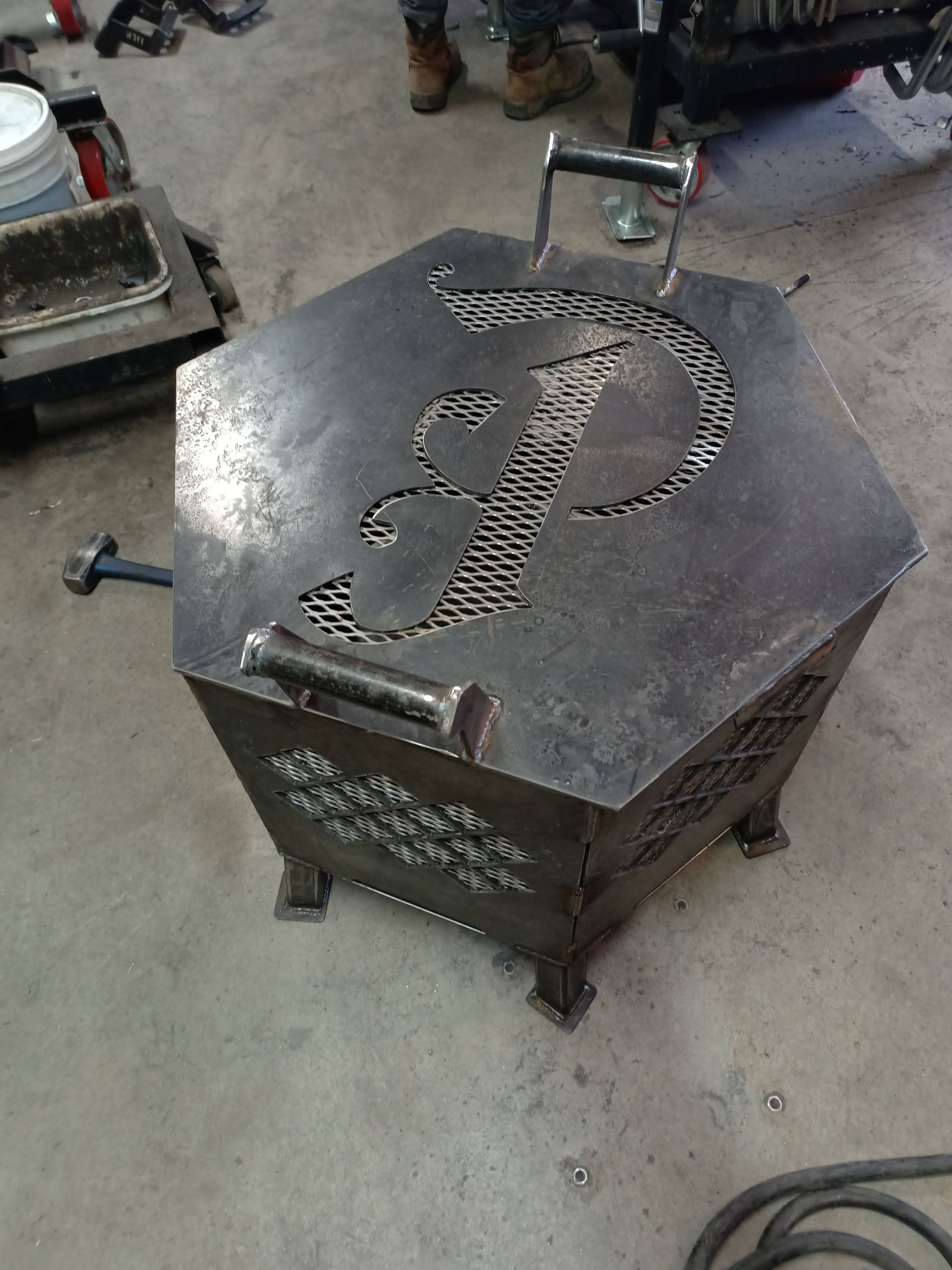 Custom welded steel hexagon firepit with monogram