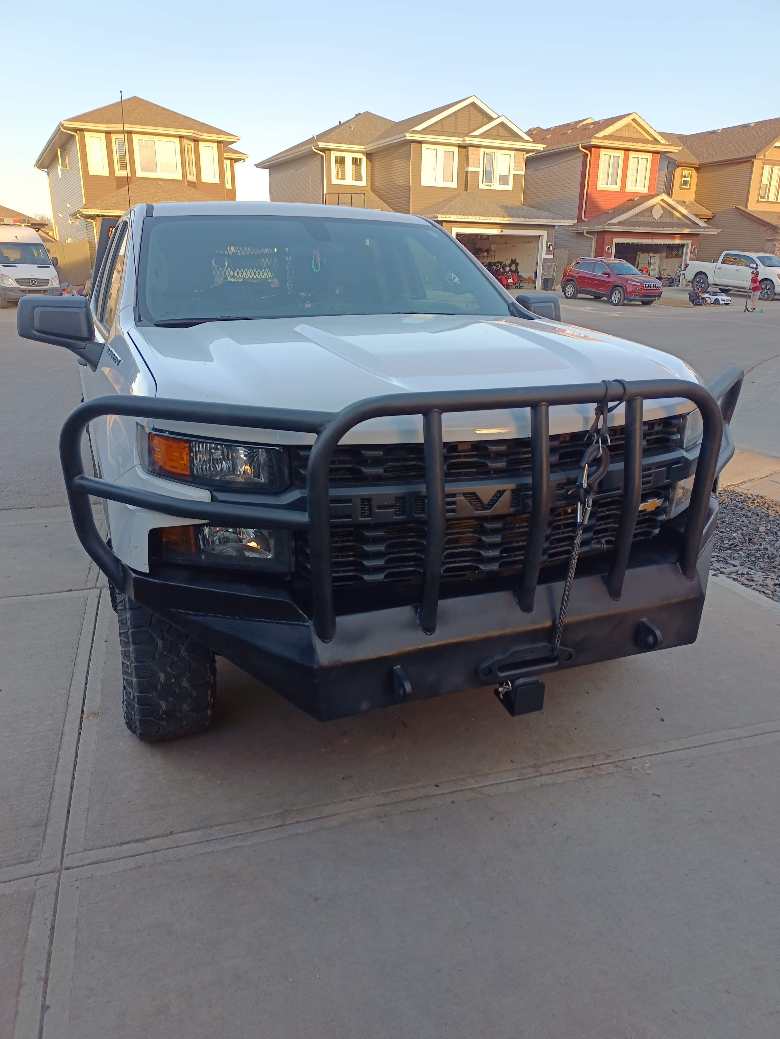 Custom off road Chevy Silverado front bumper with full coverage grille guard, hidden winch mount and front receiver