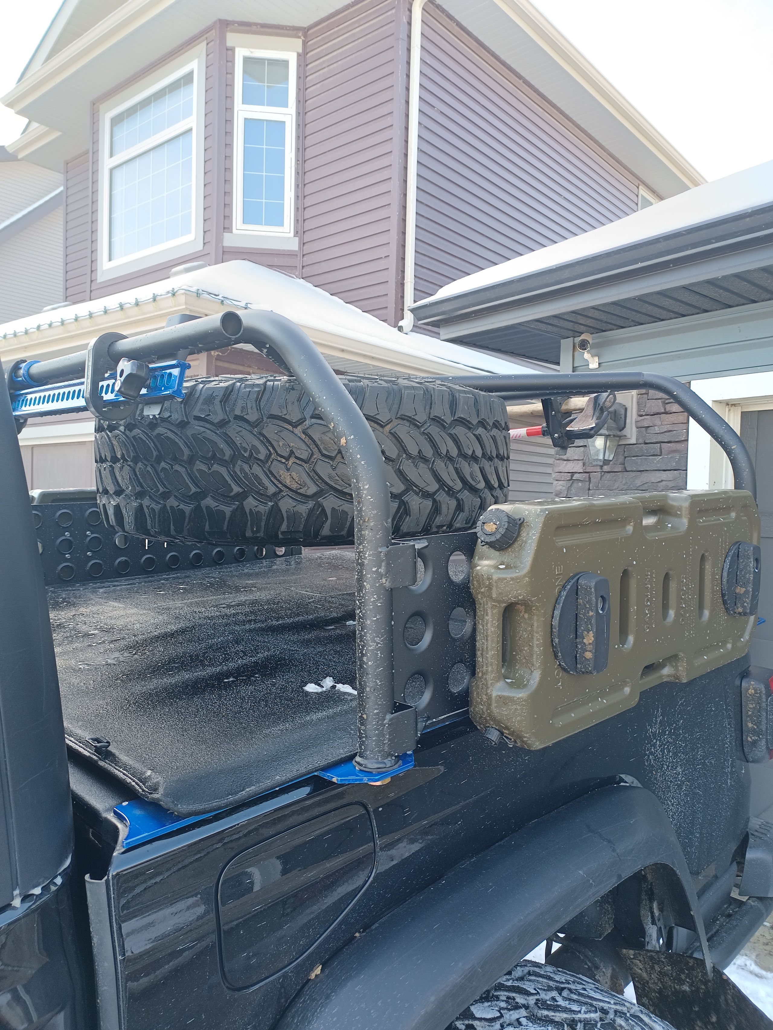 Custom Jeep Gladiator bed rack with spare tire mount, axe/shovel and hi-lift mount and dual fuel can carriers